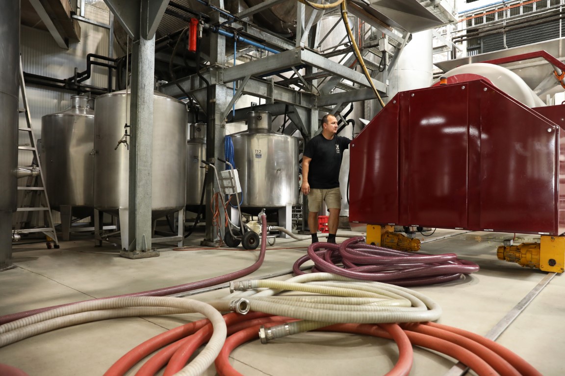 A man surrounded by metal barrels 